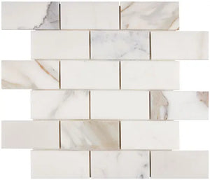 Calacatta Gold honed 2×4 brick marble mosaic.
