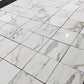 Glossy Calacatta Gold 18x18 tiles with distinctive gray veining, ideal for luxury bathrooms and kitchens.