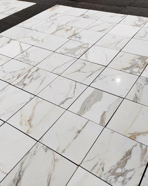 Glossy Calacatta Gold 18×18 tiles with distinctive gray veining, ideal for luxury bathrooms and kitchens.