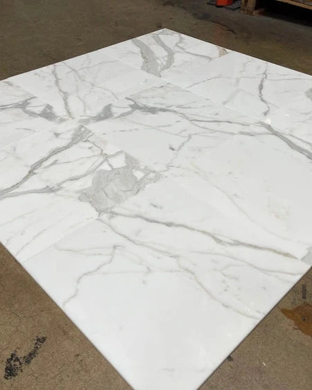 a close up image - Calacatta Gold Marble 24x24 Tile dry-lay showcasing luxury main floor selection from in-stock inventory