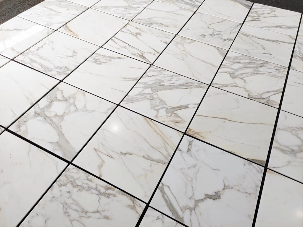 Calacatta Gold 24×24 inches marble tile with natural white, gray, and gold veining.