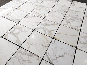 Calacatta Gold 24×24 inches marble tile with natural white, gray, and gold veining.
