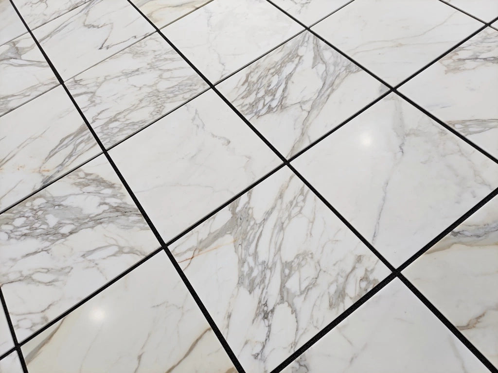Calacatta Gold 24×24 inches marble tile with natural white, gray, and gold veining.