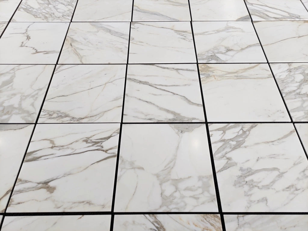 Calacatta Gold 24×24 inches marble tile with natural white, gray, and gold veining.