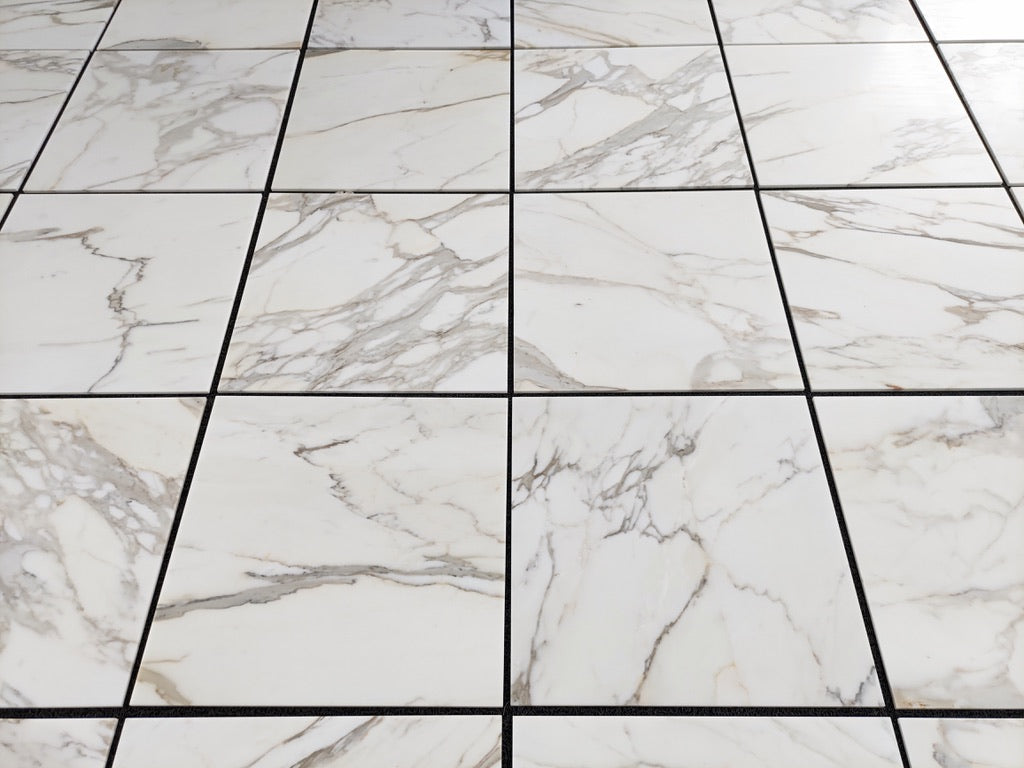 Calacatta Gold 24×24 inches marble tile with natural white, gray, and gold veining.