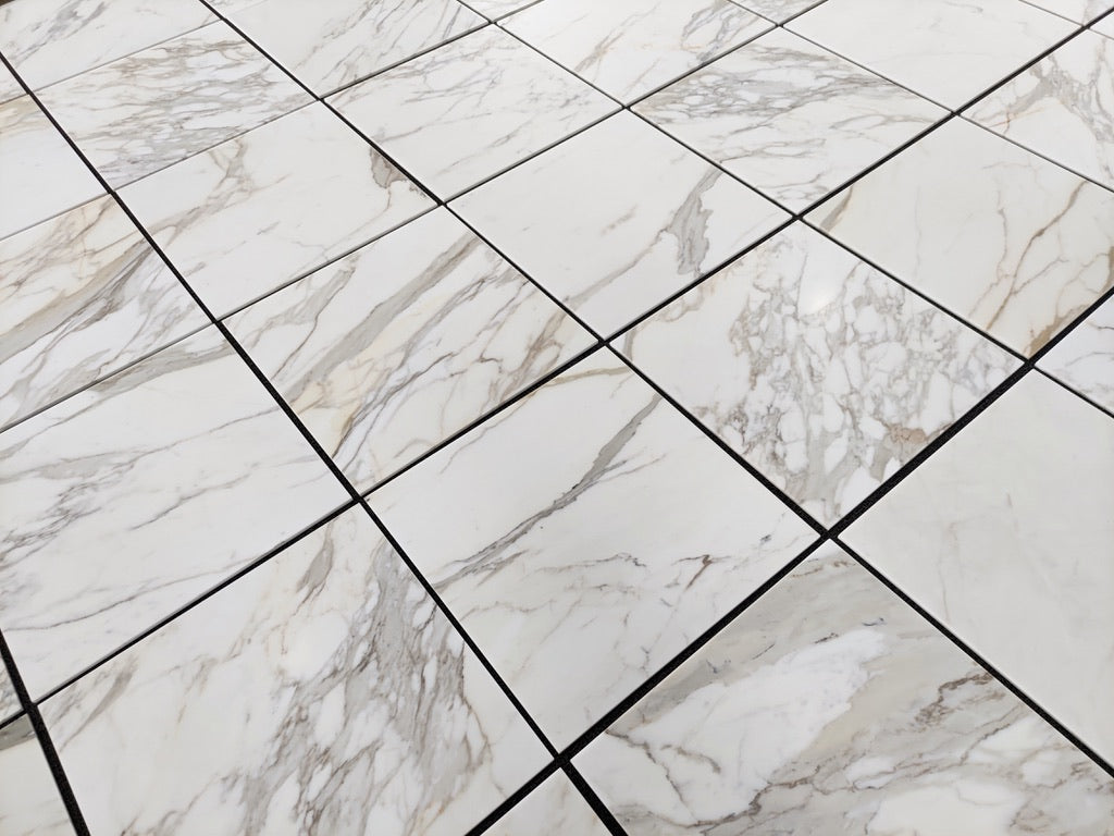 Calacatta Gold 24×24 inches marble tile with natural white, gray, and gold veining.