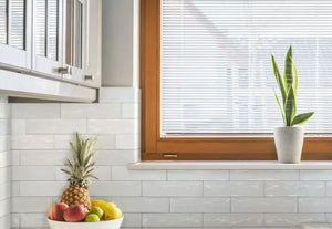 Colina Blanco glossy ceramic wall tile installed as a kitchen backsplash.