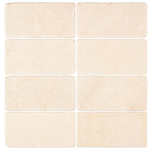 Crema Marfil marble 3×6 subway tile with a tumbled finish.