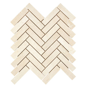 Crema Marfil marble 1×4 herringbone mosaic with a honed finish.