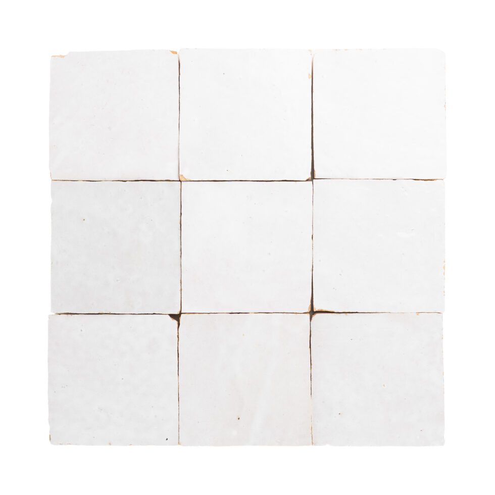 White square zellige tiles with brown grout on a white background