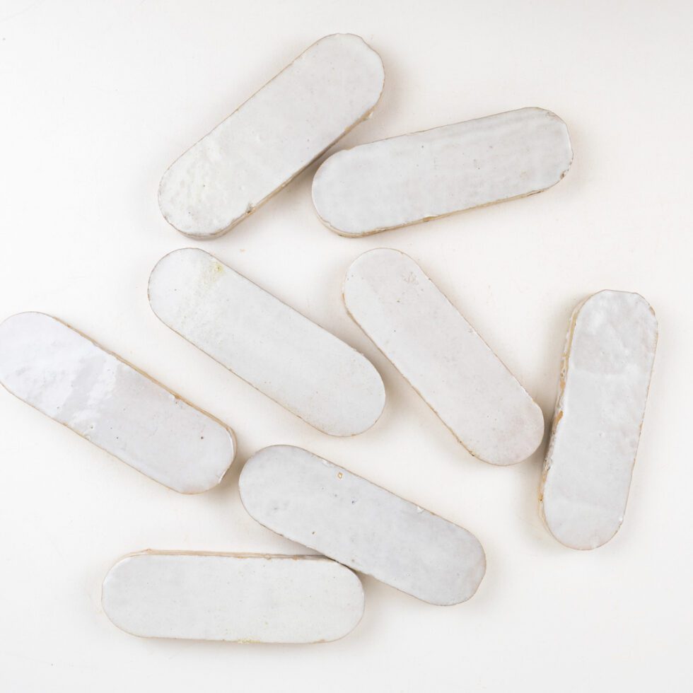 White oval zellige mosaic tiles on a white background