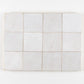 White zellige tiles with subtle variations on a white background