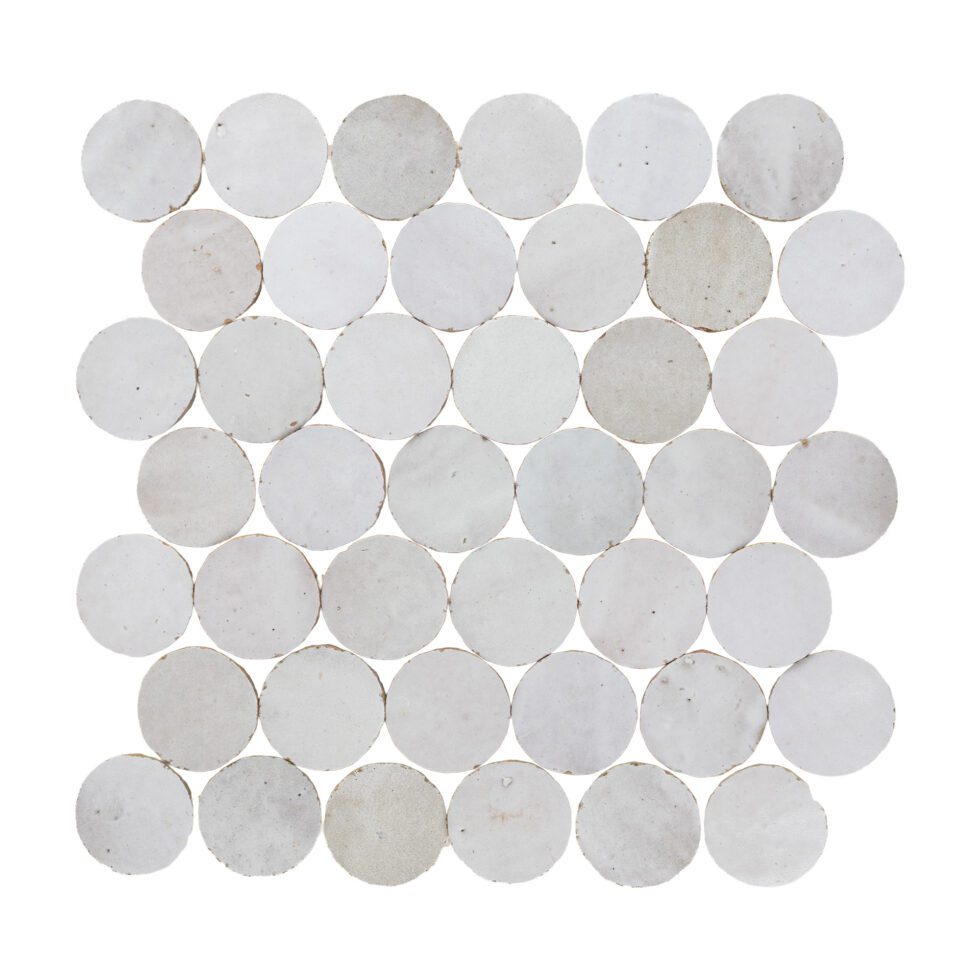 White circular hand-made zellige mosaic tiles arranged in a pattern on a white background