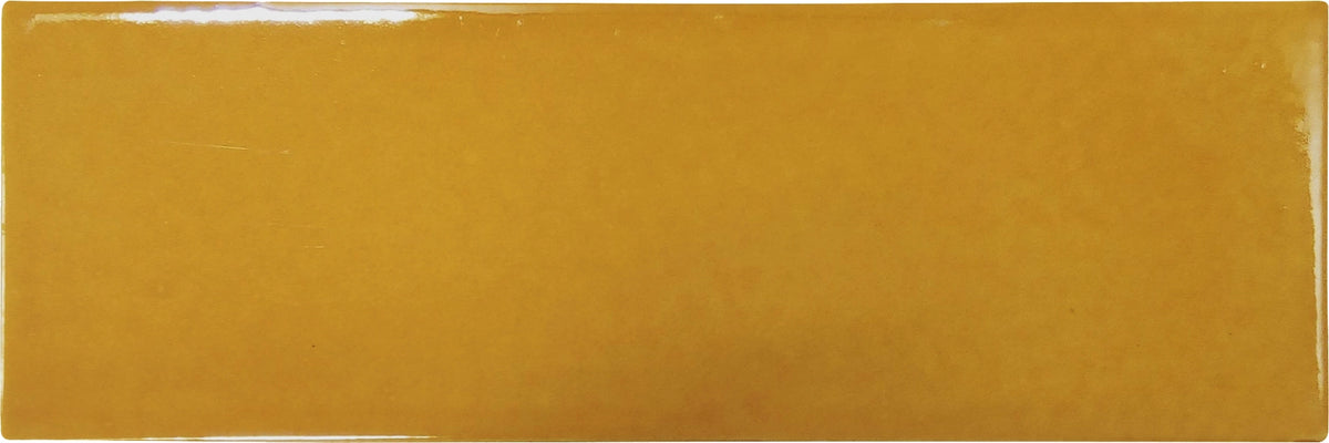 Fez Amber Flame glossy 2×6 ceramic wall tile close-up showing color variation.