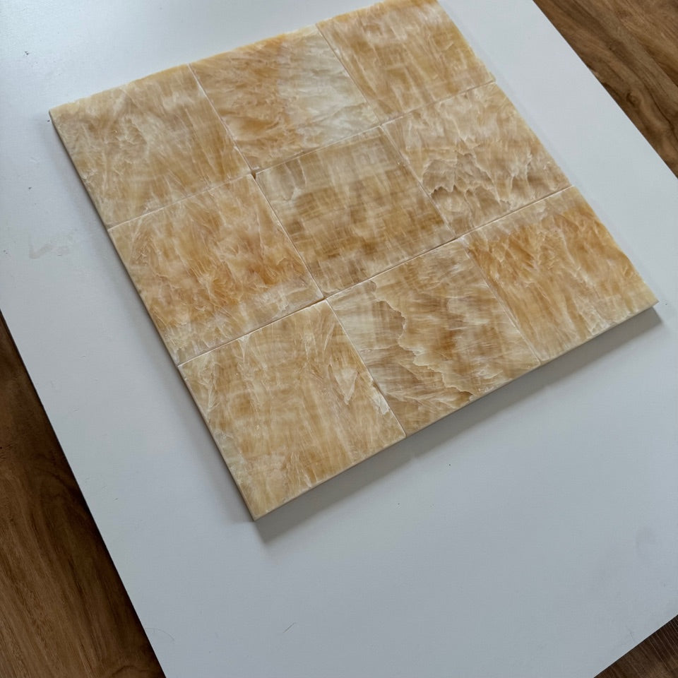 A luxurious combination of Honey Onyx tiles in a checkerboard arrangement with Bianco Dolomite. This unique tile design brings warmth and contrast to any space, perfect for floors, walls, or backsplashes.