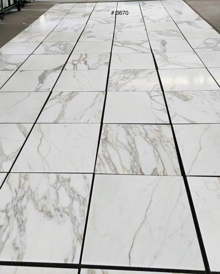 24x24 Calacatta Gold tile with soft white tones and striking gold veining, adding elegance to high-end flooring projects.