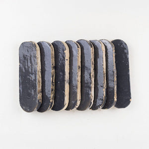 Row of indigo color oval zellige tiles on a white background