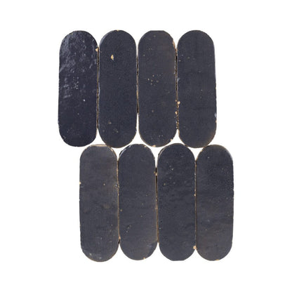 Indigo color oval-shaped zellige mosaic tile chips on a white background