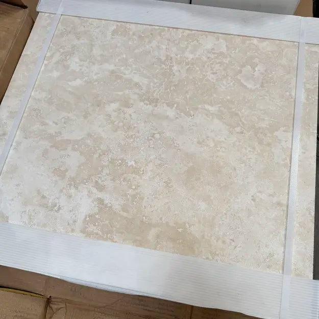 Ivory Travertine 24x24 Honed Filled_ in original Packaging for true judgment of its creamy beige tones with subtle veining