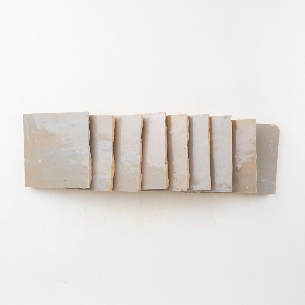 Decorative zellige wall tiles with horizontal wooden slats on a white background