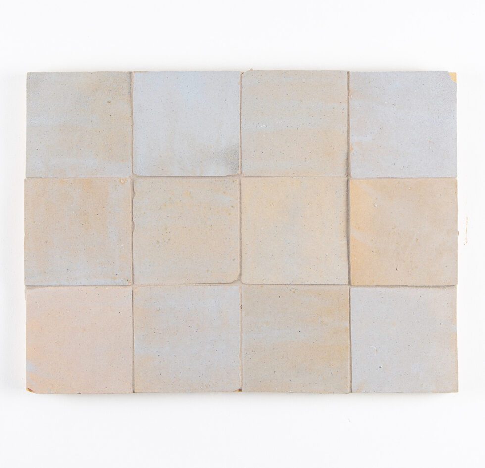 Square zellige tiles with a grid pattern on a white background