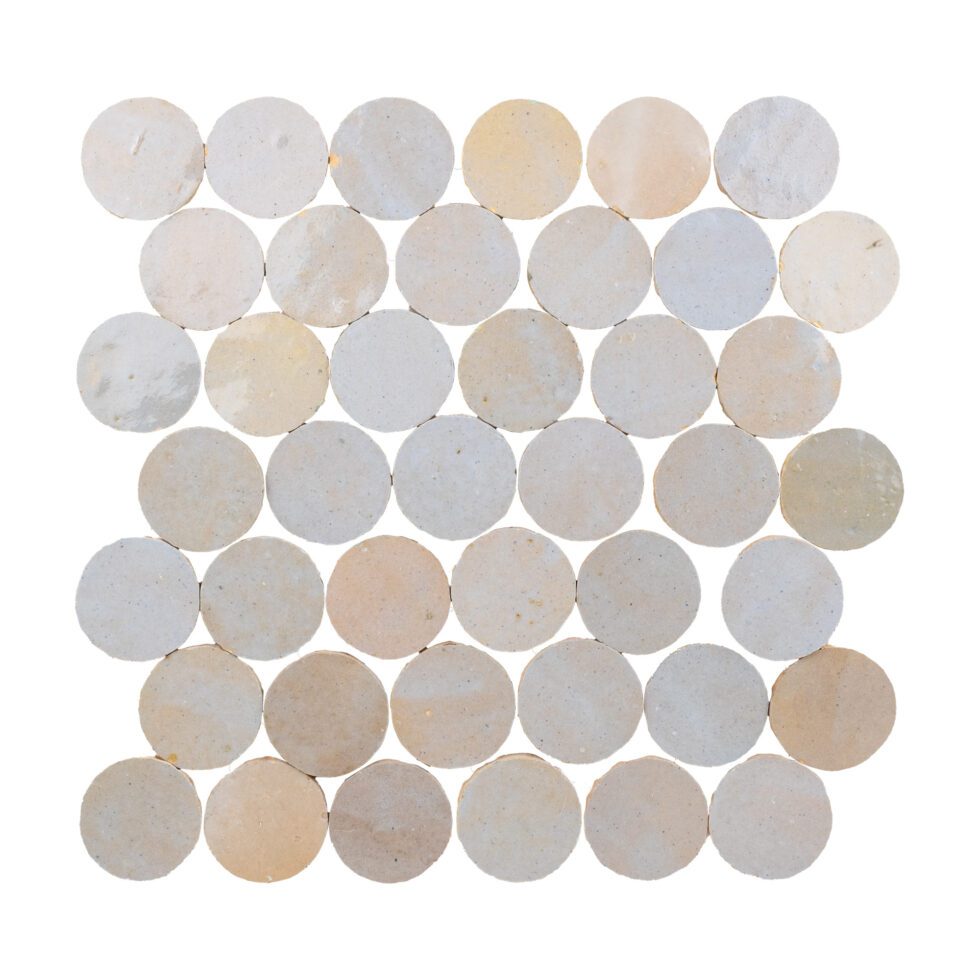 Pattern of round zellige tiles in beige and white on a white background