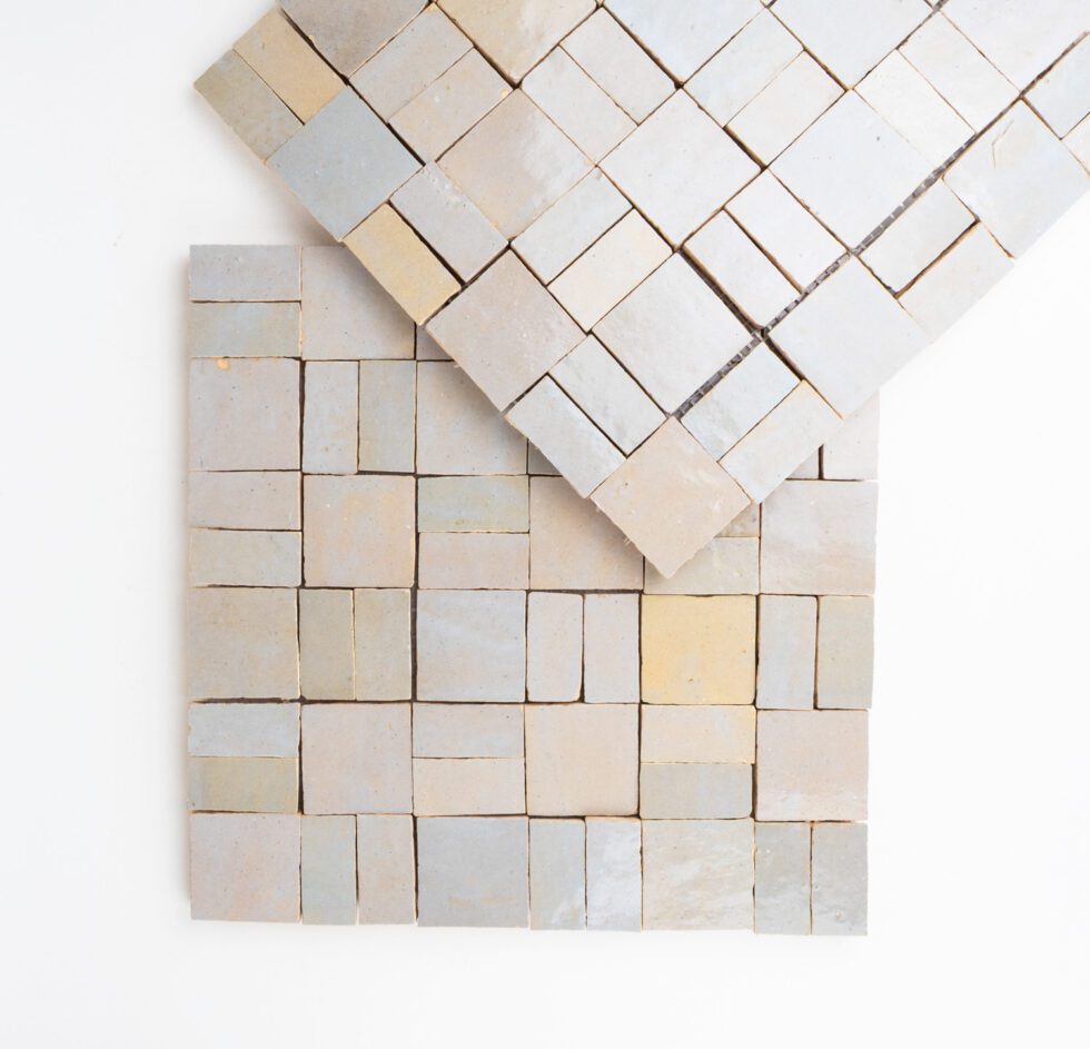 Zellige mosaic pattern of square tiles in neutral colors on a white background