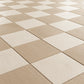 Wide 45-degree view of a porcelain checkerboard floor in ivory and beige, showing depth and repeating tile pattern.