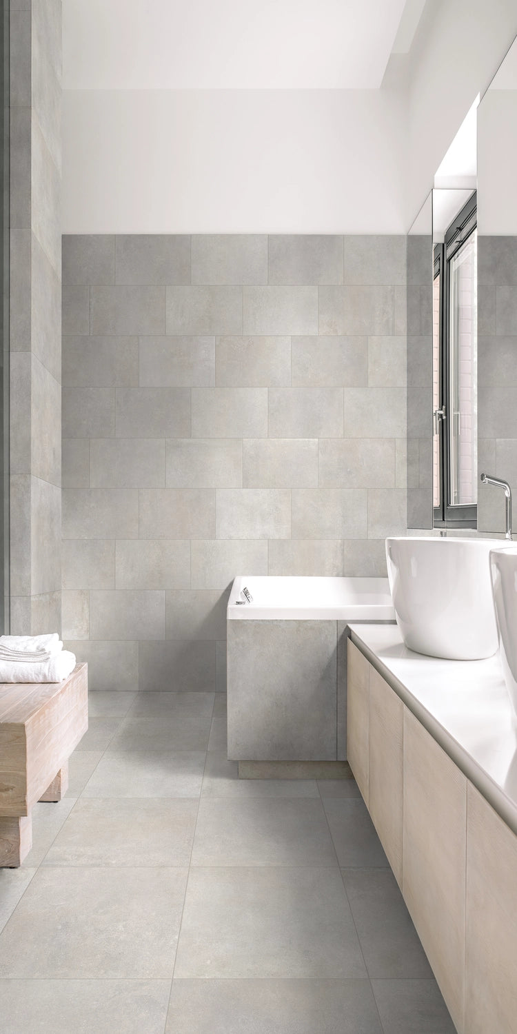 Urban White 12x24 porcelain tile adding a sleek and light finish to a modern bathroom floor and wall.