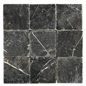 Nero Marquina 4x4 tumbled black marble subway tile with white veining for backsplashes and walls.