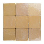Nine square zellige tiles of beige-amber color arranged in a 3x3 grid on a white background