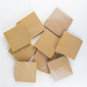 Nine square amber zellige tiles on a white background