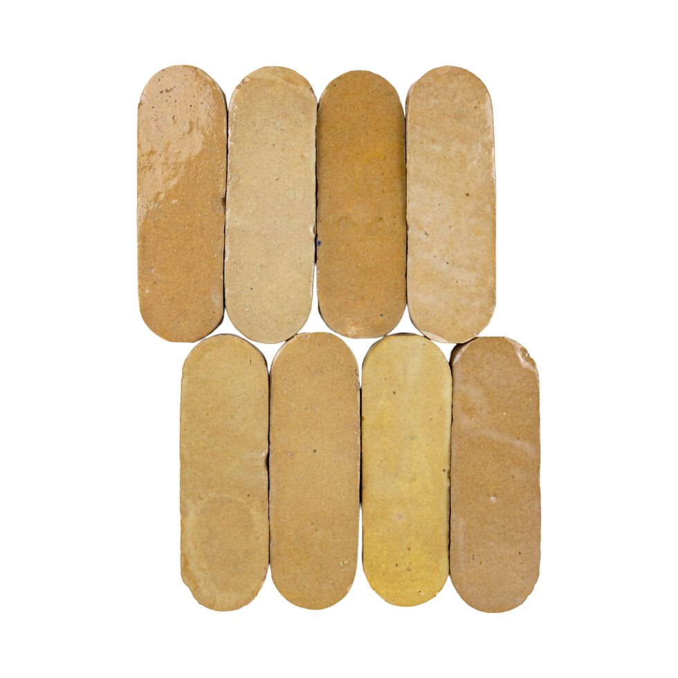 Eight oval-shaped zellige tiles in amber color arranged in a pattern on a white background