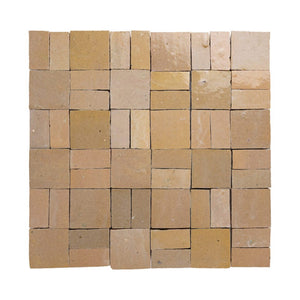 Square arrangement of beige zellige tiles on a white background