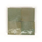 Four square Oasis Green Zellige tiles with a green and brown pattern on a white background