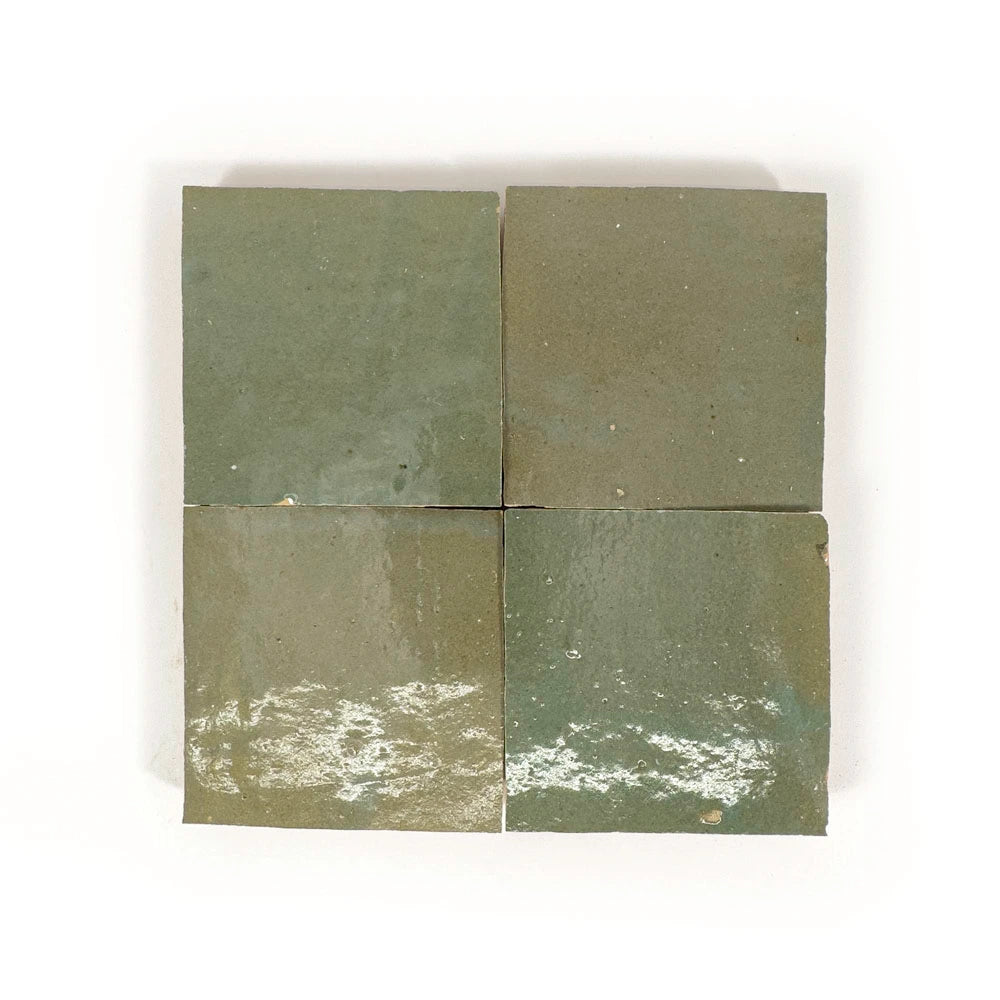 Four square Oasis Green Zellige tiles with a green and brown pattern on a white background