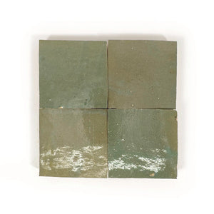 Four square Oasis Green Zellige tiles with a green and brown pattern on a white background