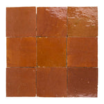 Nine square zellige tiles with a terracotta color pattern on a white background
