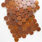 Close-up of copper penny zellige mosaic on a white background