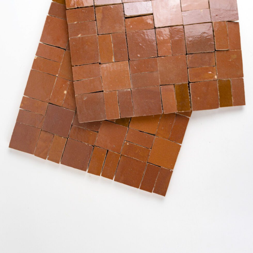 Brown square zellige tiles stacked on a white background