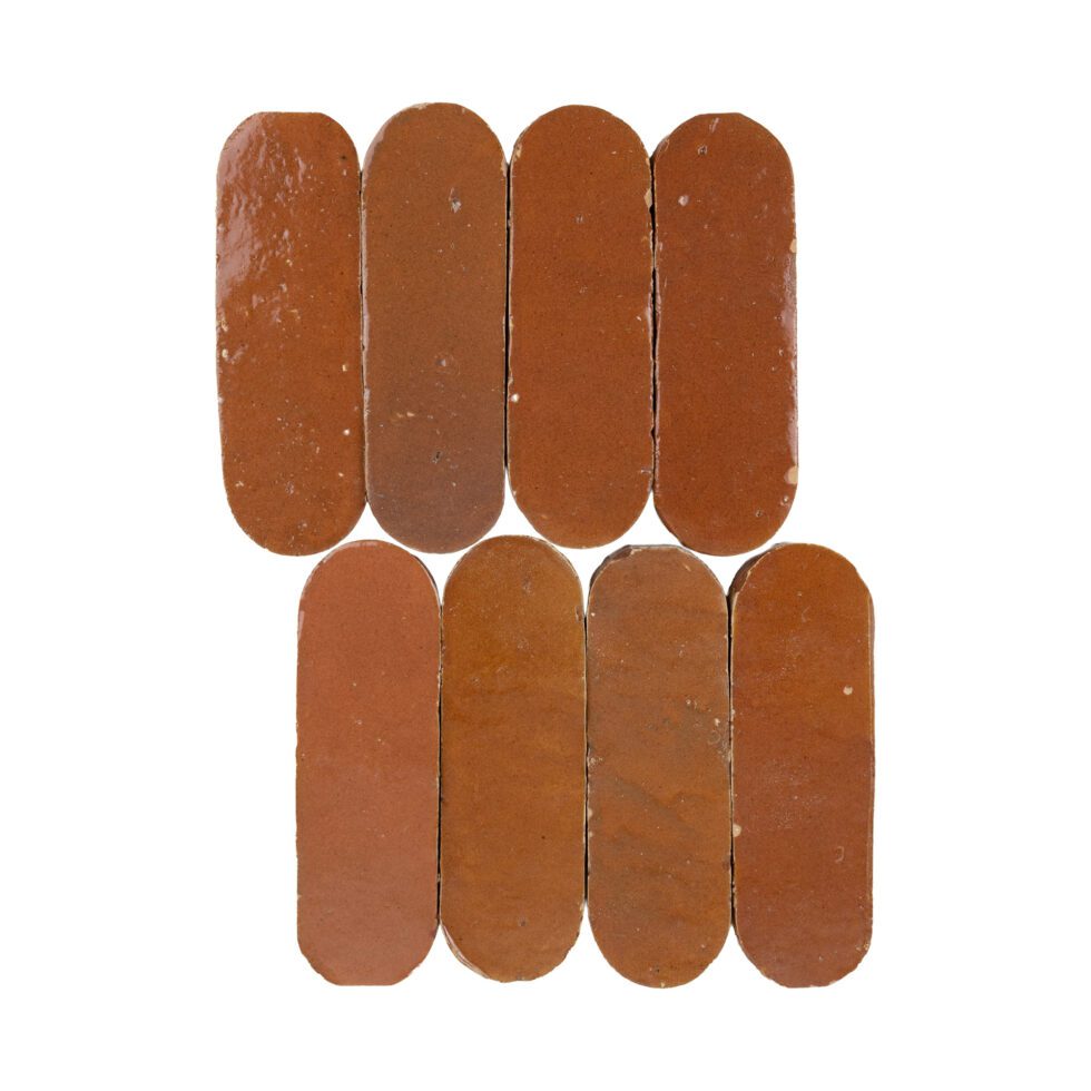 Eight brown oval-shaped terracotta zellige tiles arranged in a 3x3 grid on a white background