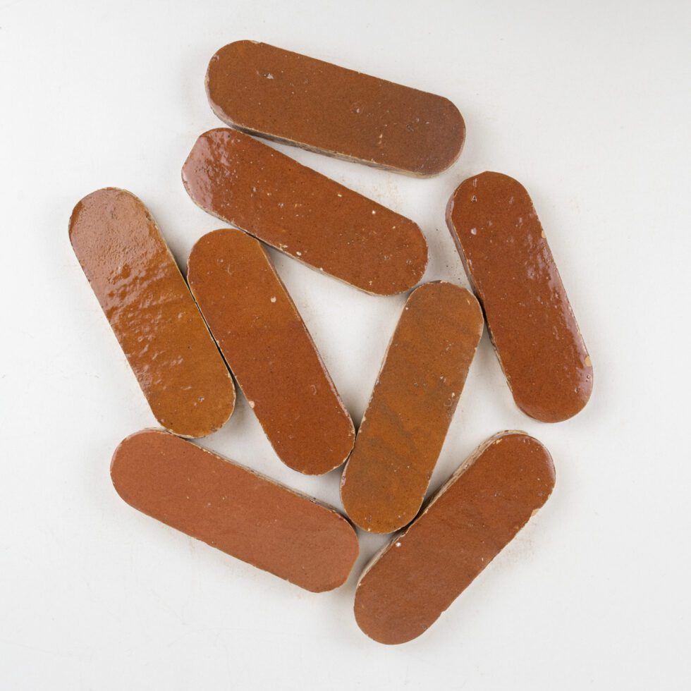 Brown oval-shaped zellige tiles on a white background