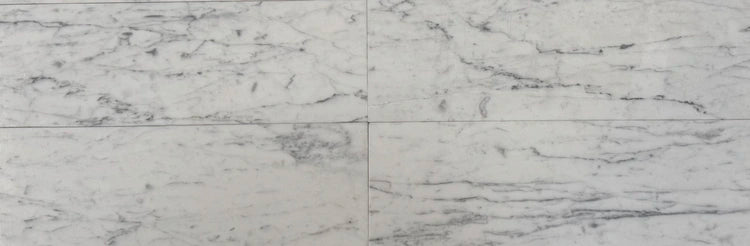 White Carrara marble subway tiles in a 4x12 format, showcasing natural gray veining and a polished finish, perfect for modern and timeless interiors.