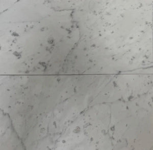 6x12 Carrara marble tiles with honed and polished options, showcasing subtle veining and a luxurious white surface for versatile applications.