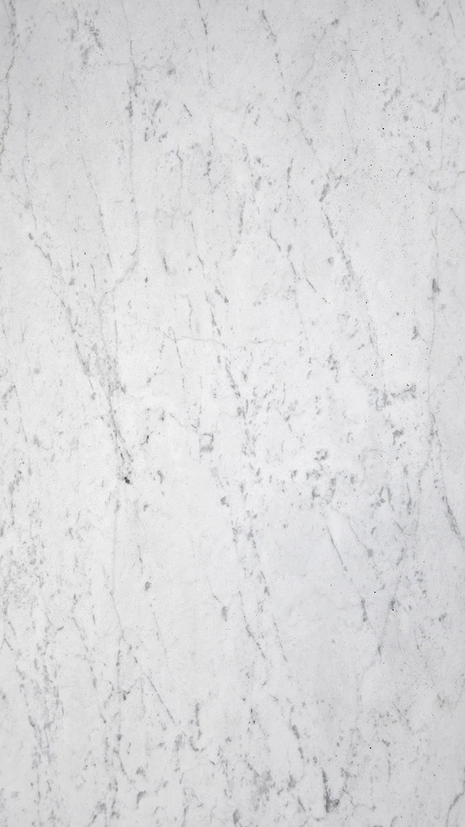 White Carrara Gioia marble large format tiles with a soft white background and subtle grey veining, showcasing a classic and refined look ideal for both modern and traditional spaces. 