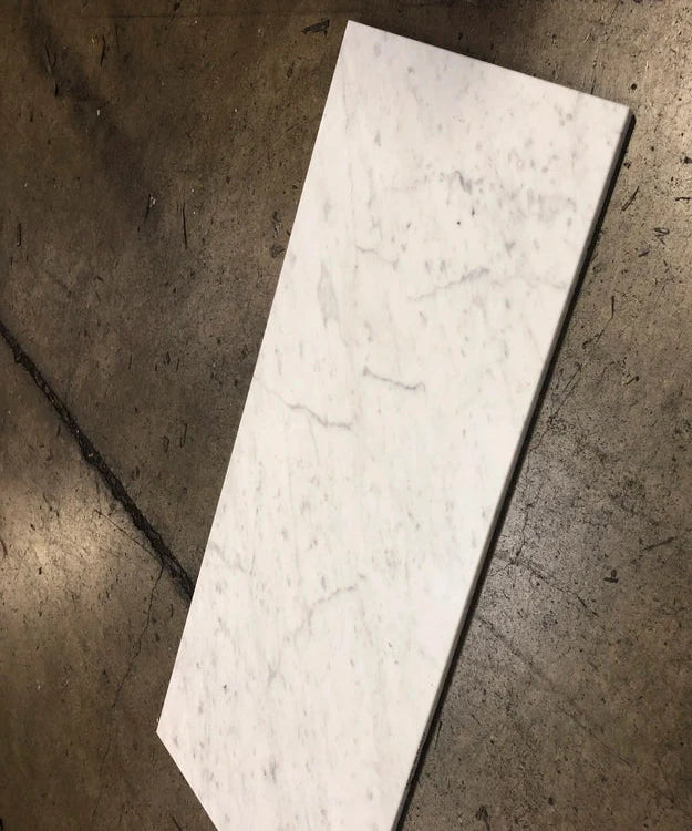 White Carrara Gioia 18x36 marble tiles dry-lay displayed for quality inspection