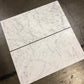 White Carrara Gioia 18x36 marble tiles dry-lay displayed for designer material color inspection