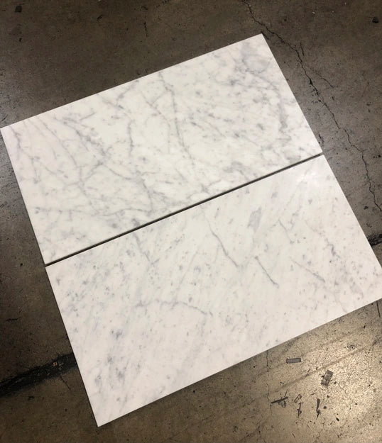 White Carrara Gioia 18x36 marble tiles dry-lay displayed for designer material color inspection