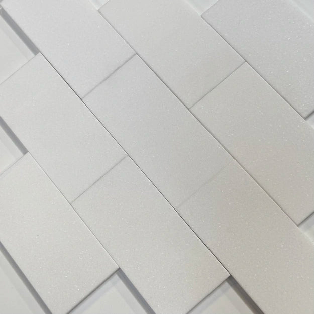 Close-up of White Thassos marble subway tiles arranged in a classic pattern, offering a sleek and elegant look for residential or commercial spaces.