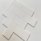 White Thassos marble subway tiles with a polished 3x6 format, arranged for a modern backsplash or wall installation.